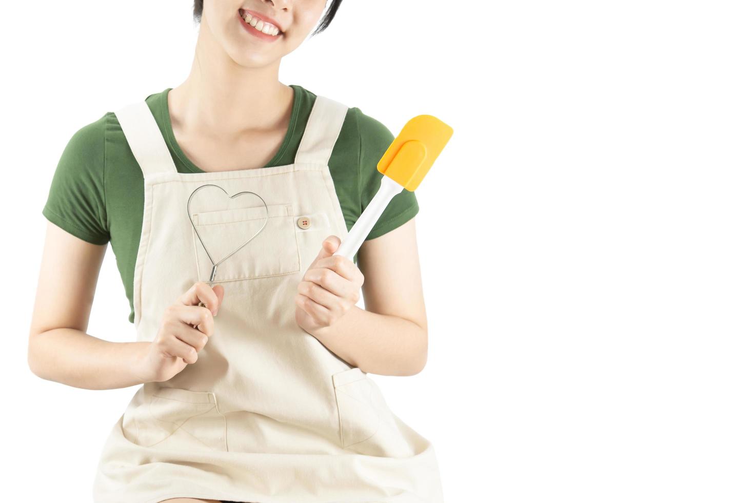 Happy lady holding kichen stuff over copy space background - people home made food preparation concept photo