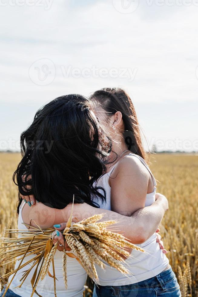 Two smiling female friends in the wheat field photo