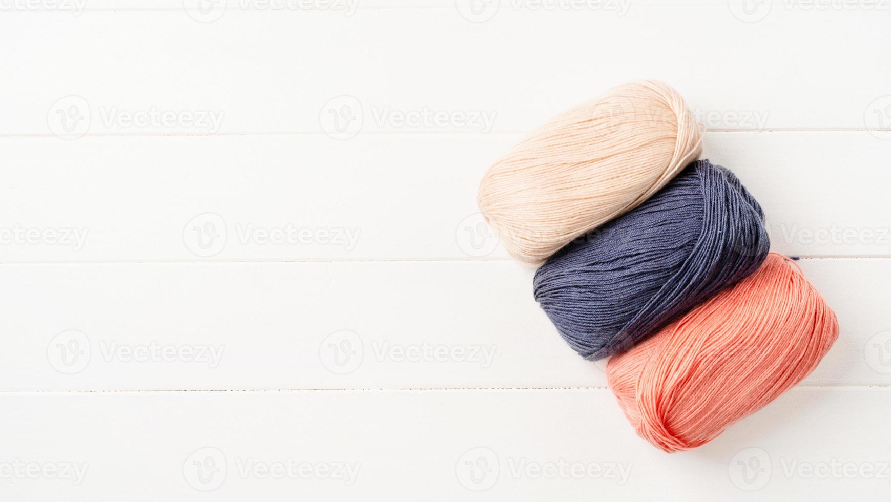 pastel colored yarn wool on marble background photo