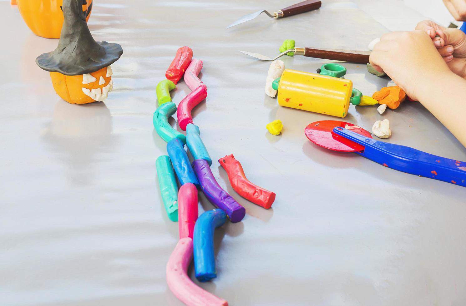 Boy is happily playing clay toy photo