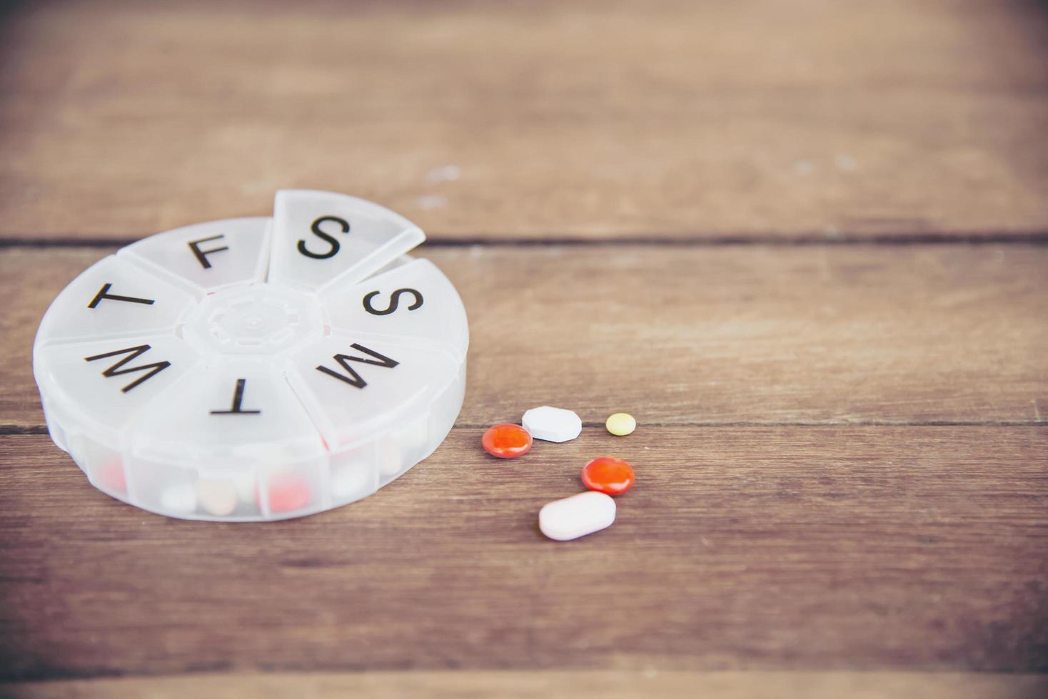 People prepare daily medicine tablet in pillbox - people healthcare with medicine pills concept photo