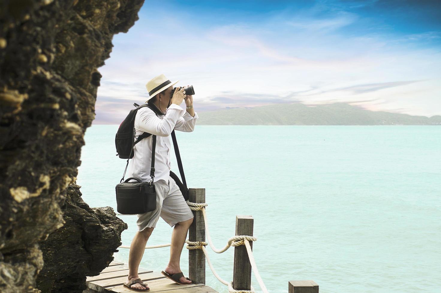 Man taking seascape photo