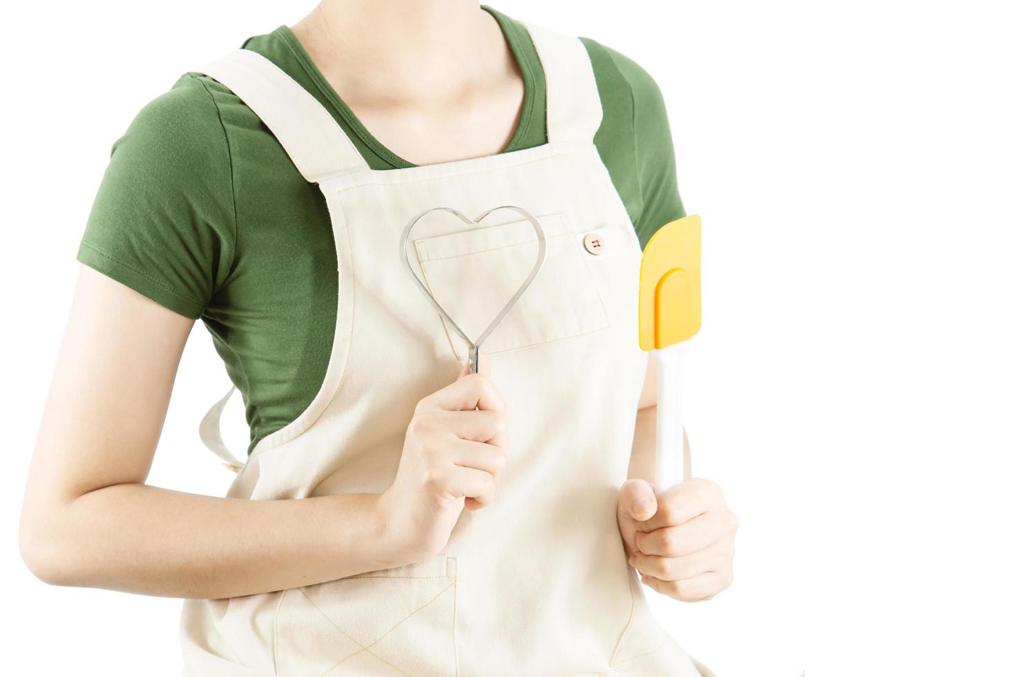 Happy lady holding kichen stuff over copy space background - people home made food preparation concept photo