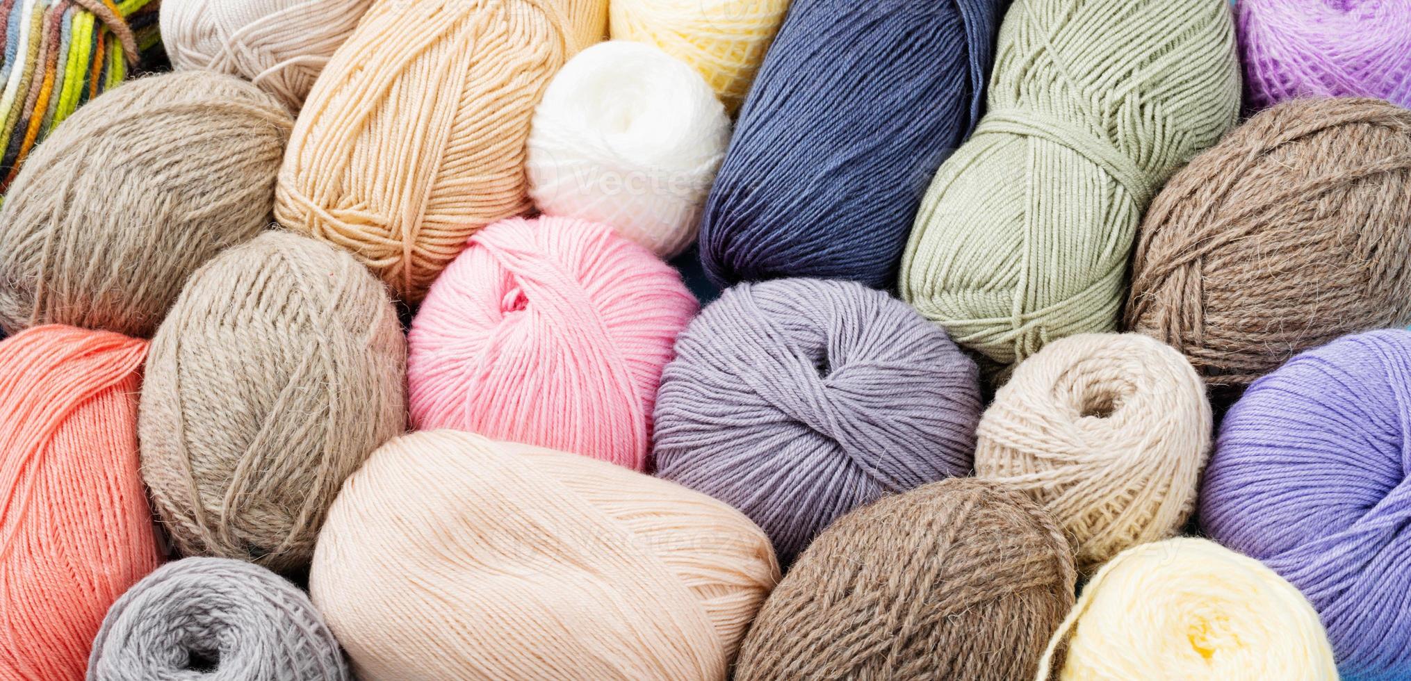 pastel colored yarn wool on shopfront. Knitting background, a lot of
