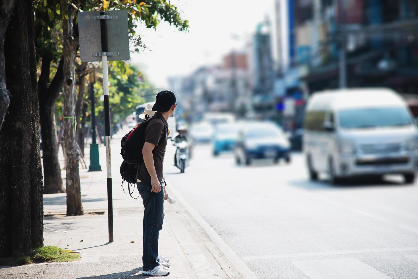 Tourist man waiting for crossing the road in Chiang mai City, Thailand - Asian travel tourist people in city concept photo