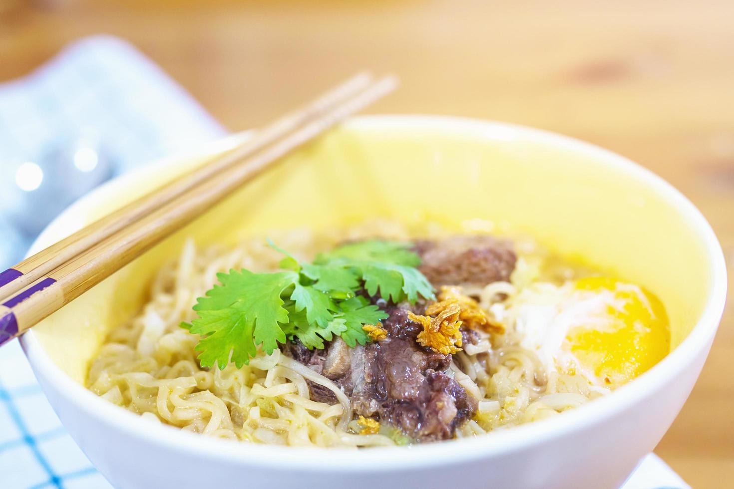 Instant noodle with pork and egg ready to be eaten - delicious instant food menu concept photo
