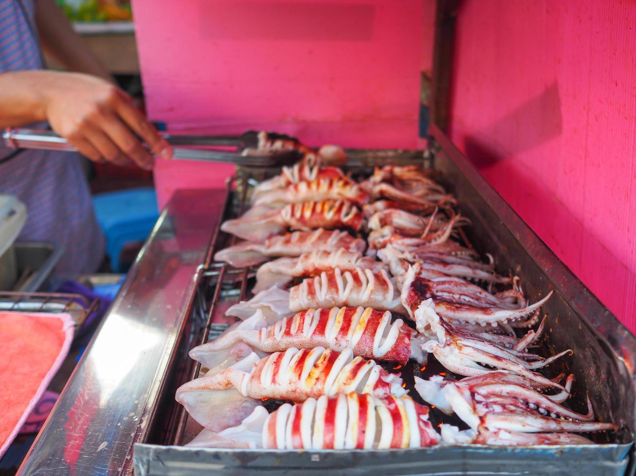 Close-up of grilling squids for sale in the market photo