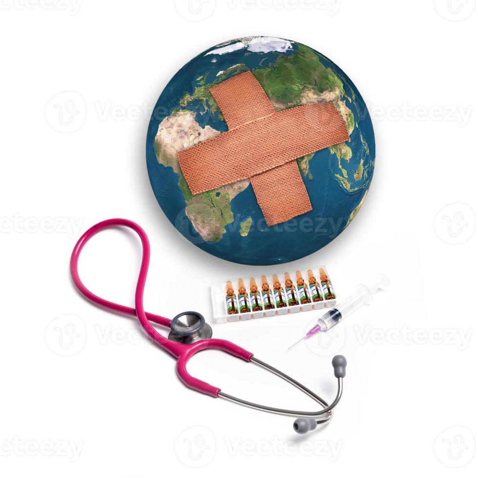 Earth with adhesive plaster with syringe and stethoscope photo