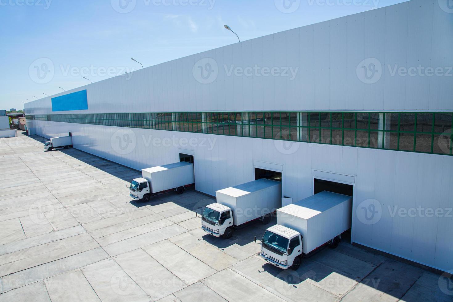 A perspective shot of some tracks coming out of a minimalist warehouse building. photo