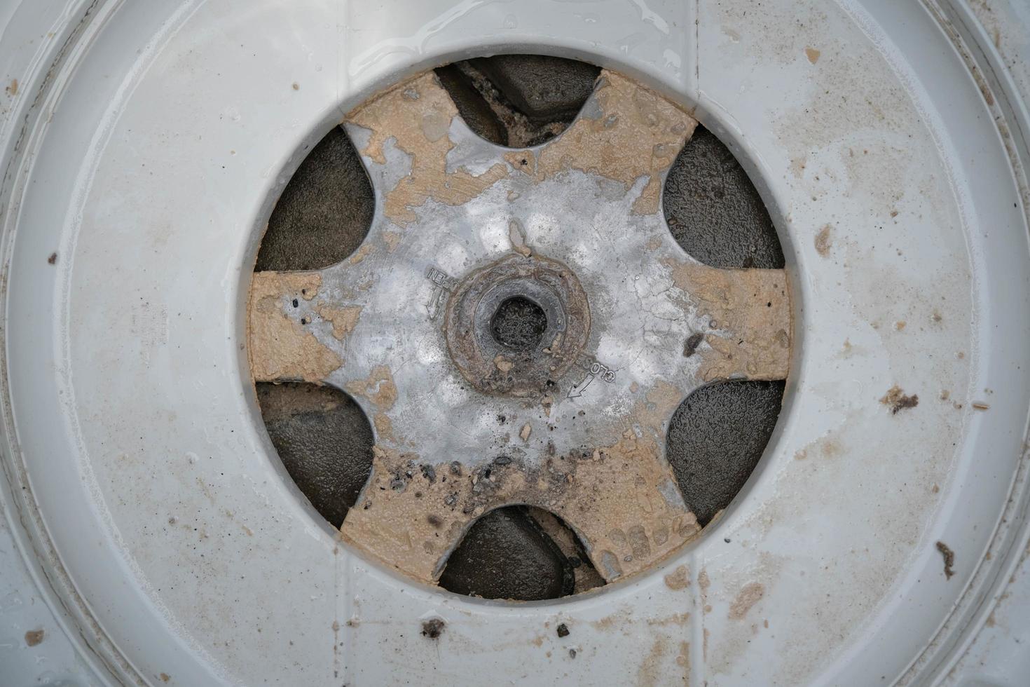 Inside of the washer drum is dirty stains, musty smell, household appliances. Washing machine