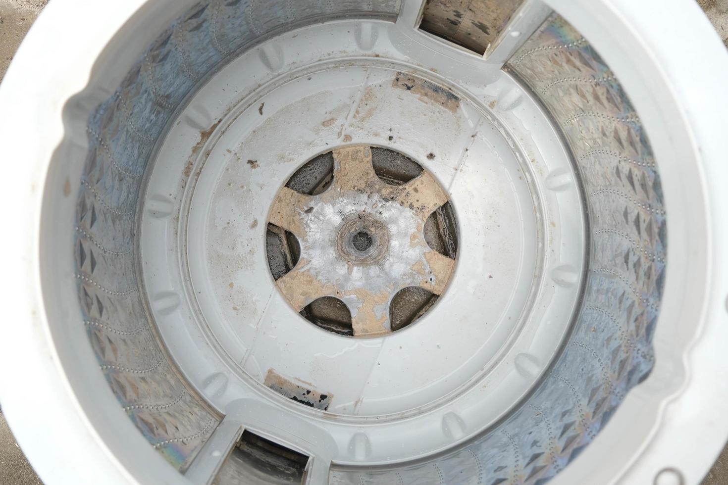 Inside of the washer drum is dirty stains, musty smell, household appliances. Washing machine
