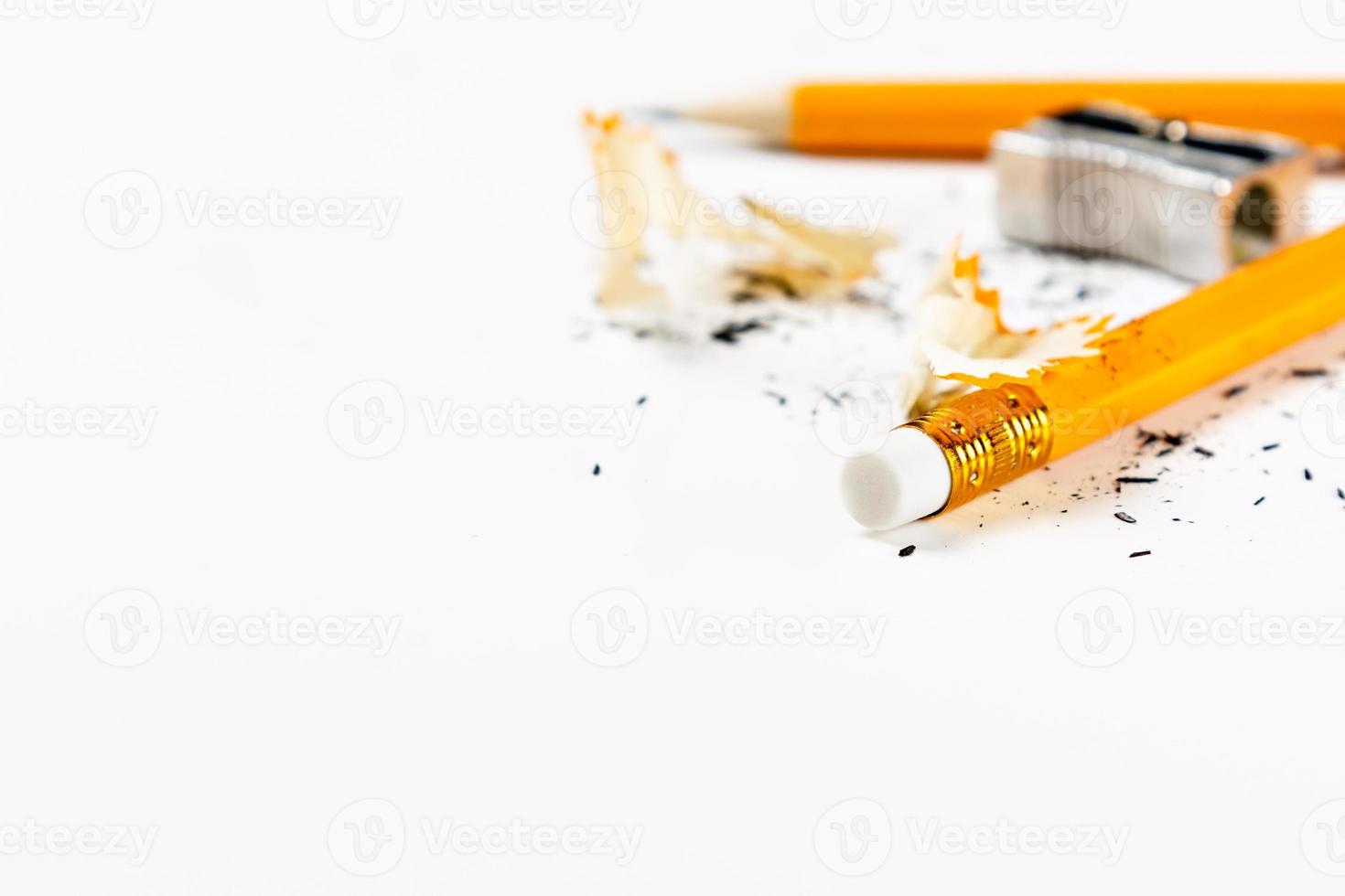 Pencil, metal sharpener and pencil shavings on white background. Horizontal image. photo
