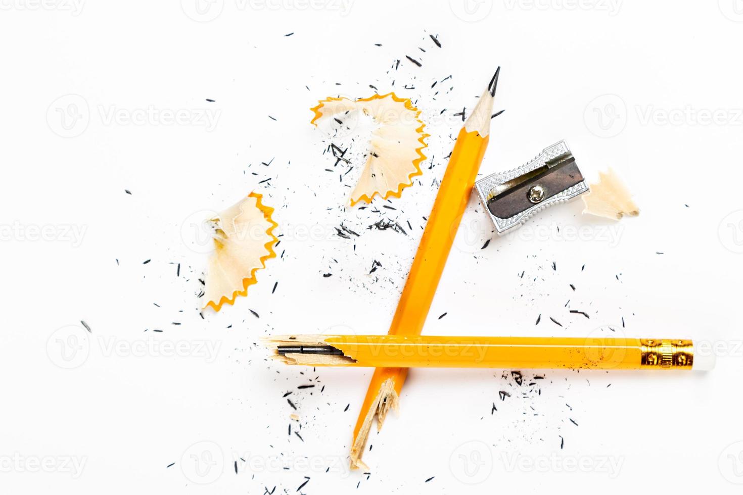 Pencil, metal sharpener and pencil shavings on white background. Horizontal image. photo