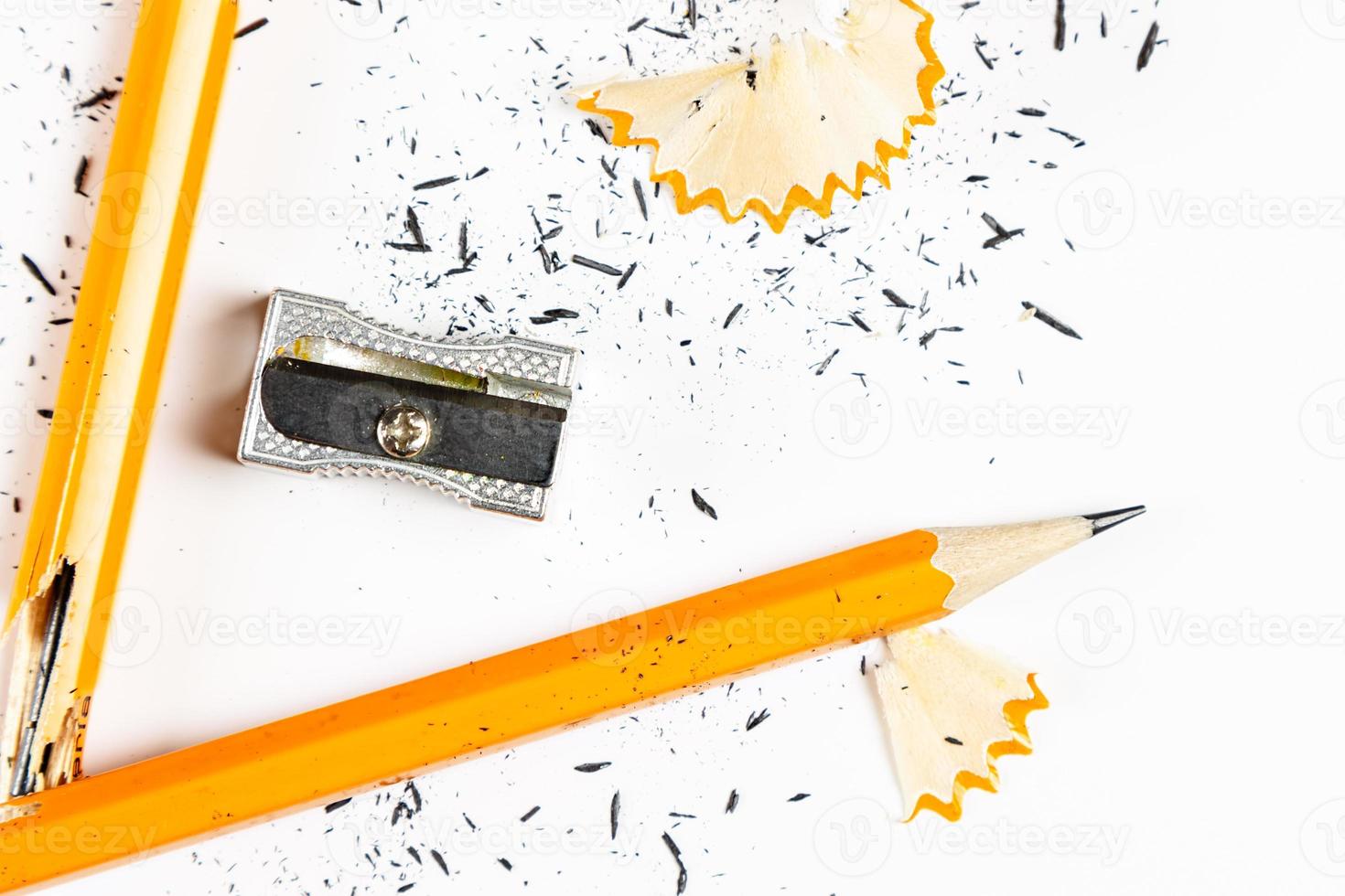 Pencil, metal sharpener and pencil shavings on white background. Horizontal image. photo