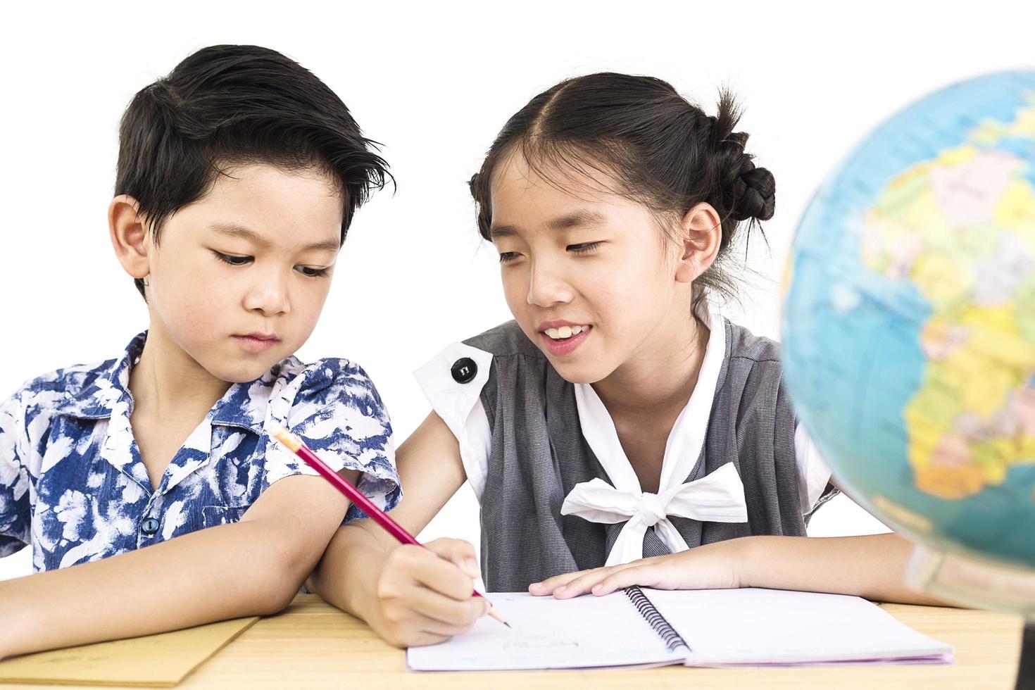 Los niños asiáticos están estudiando el mundo sobre fondo blanco. foto