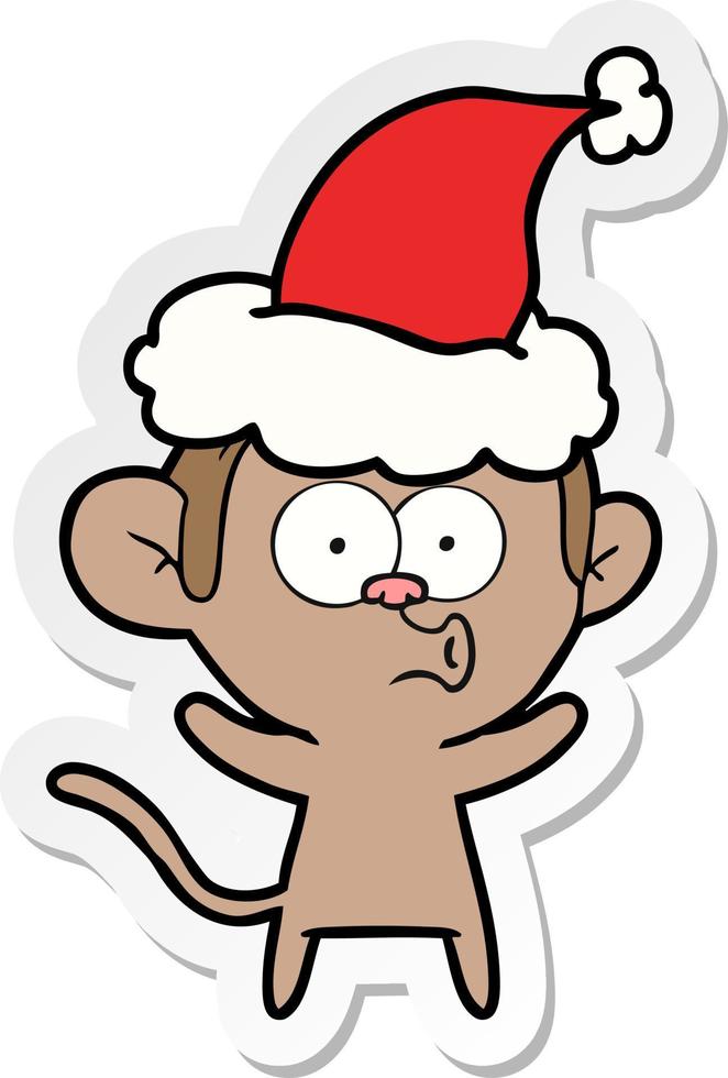 sticker cartoon of a surprised monkey wearing santa hat vector