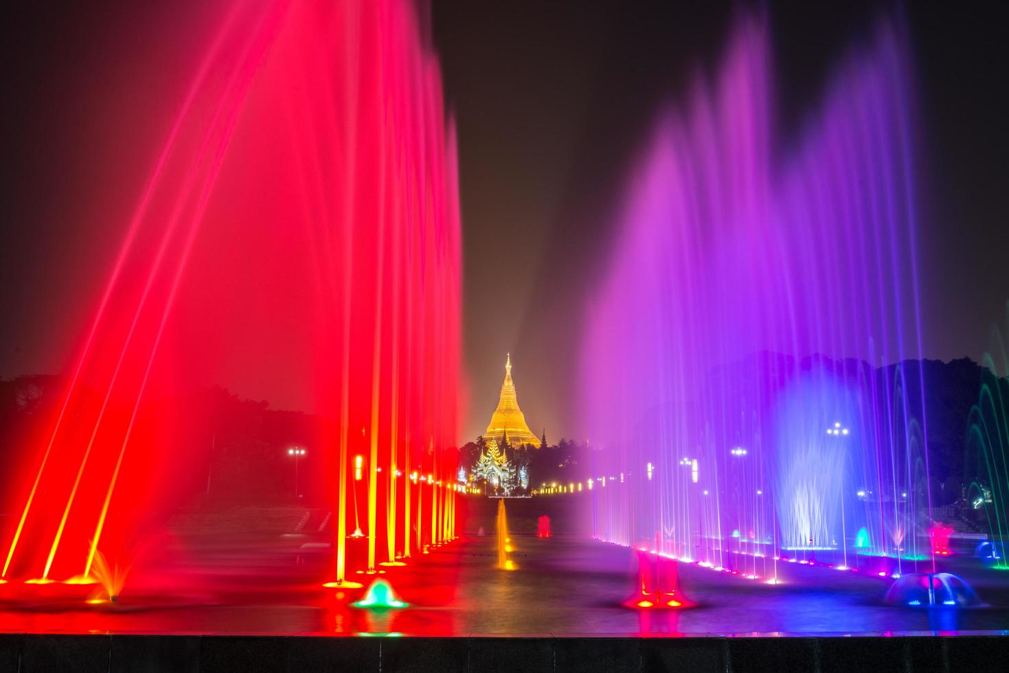 The colourful fountain show in people's park with the view of Shwedagon pagoda in Yangon, Myanmar at night. photo