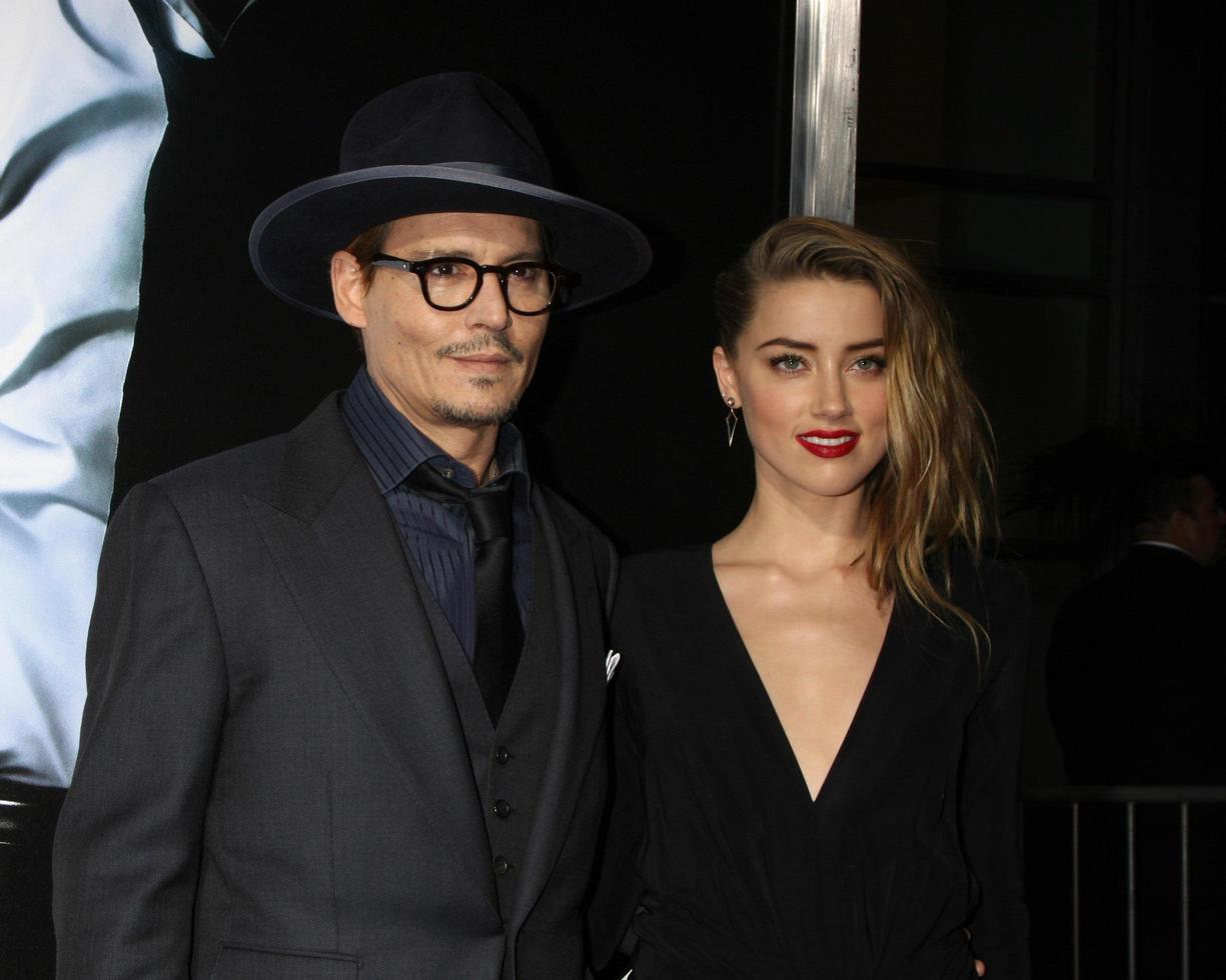 LOS ANGELES, FEB 12 -  Johnny Depp, Amber Heard at the 3 Days to Kill LA Premiere at ArcLight Hollywood Theaters on February 12, 2014 in Los Angeles, CA photo