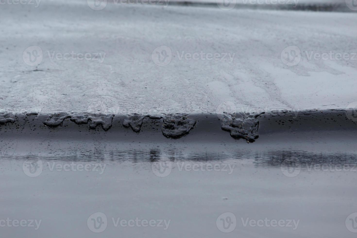 crude oil spill on the beach photo