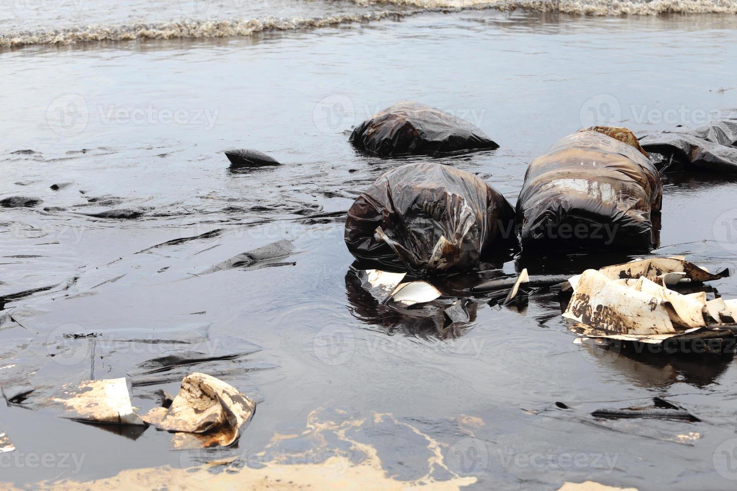 Water pollution - old garbage and oil photo