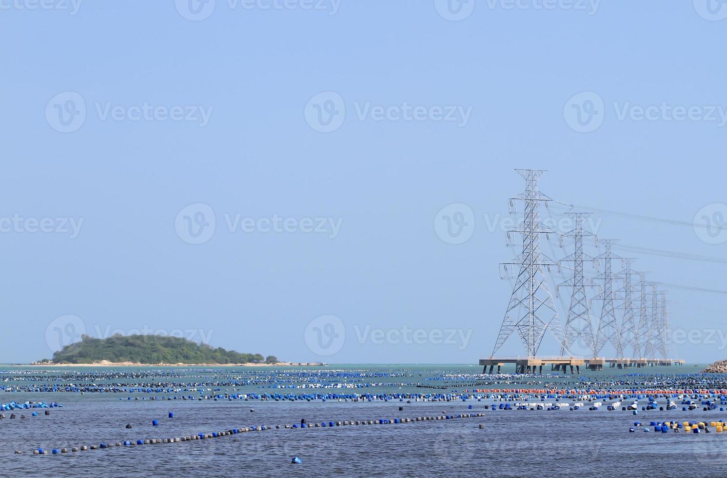 High voltage power pole in the sea photo