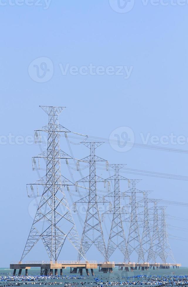 High voltage power pole in the sea photo