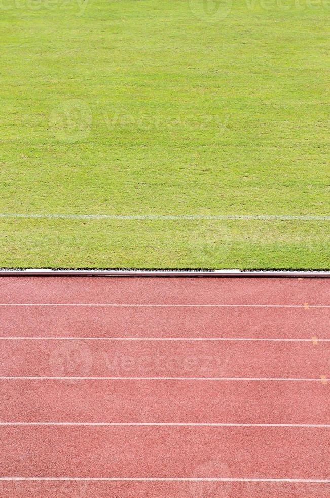Running track with grass field photo