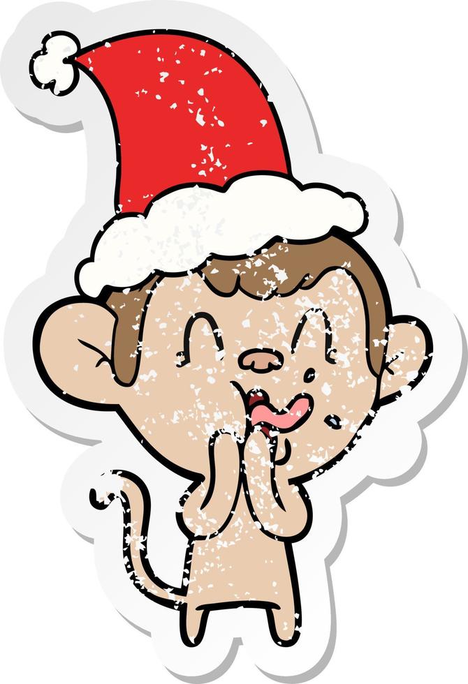 crazy distressed sticker cartoon of a monkey wearing santa hat vector