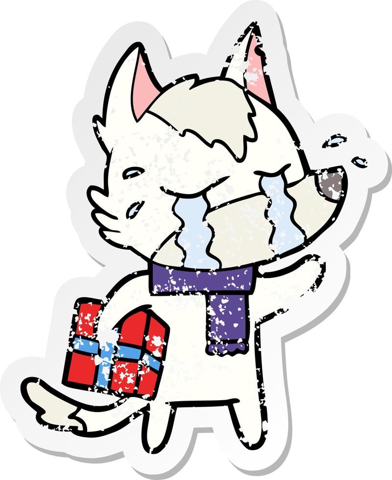 distressed sticker of a cartoon crying wolf with christmas present vector