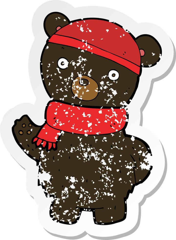 retro distressed sticker of a cartoon black bear in winter hat and scarf vector