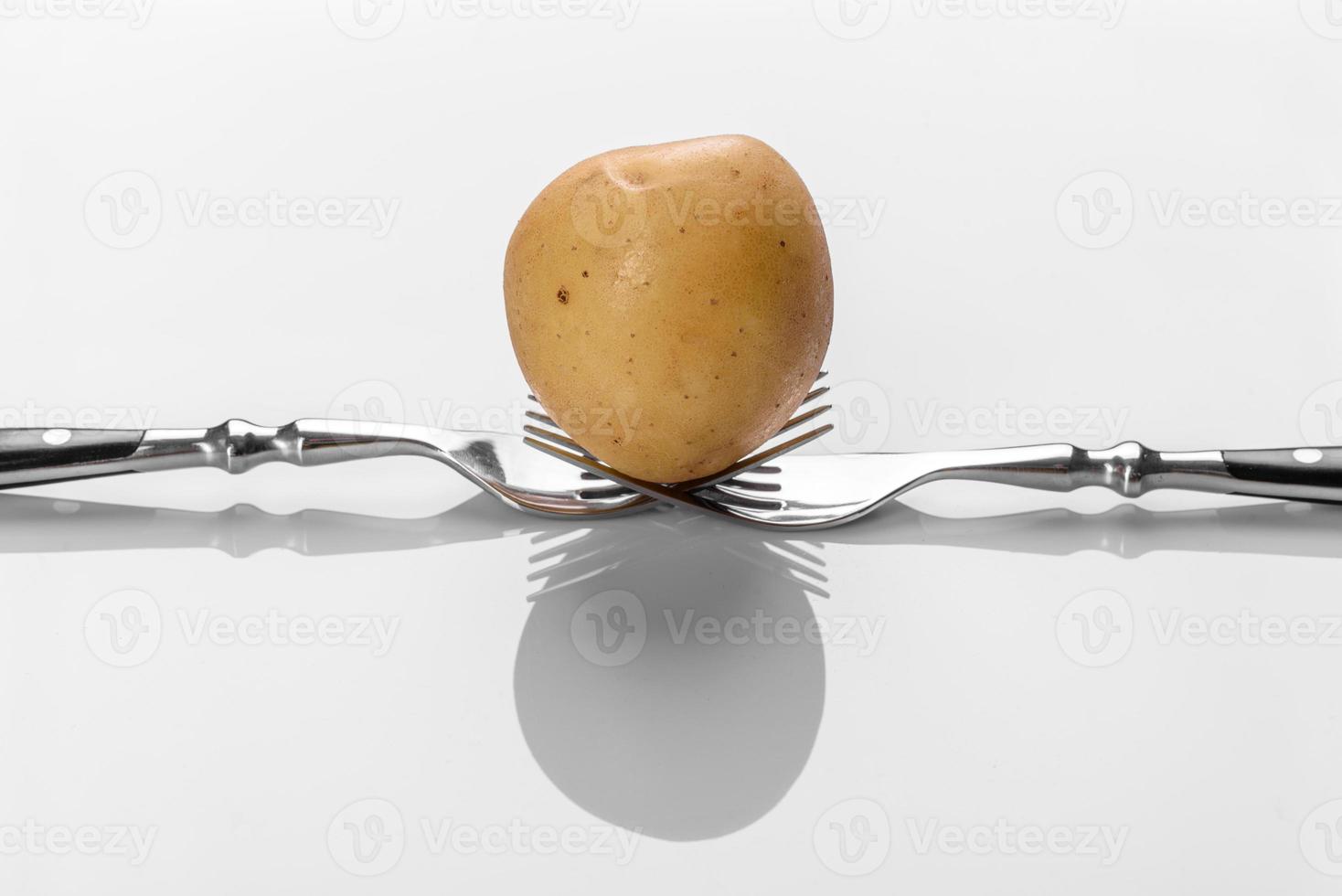 A pile of young potatoes on the table. The benefits of vegetables photo