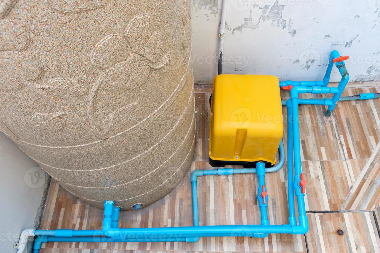The automatic water pump and the large water tank for the distribution system. photo
