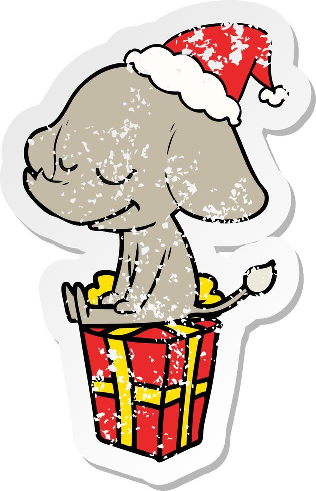 distressed sticker cartoon of a smiling elephant wearing santa hat vector
