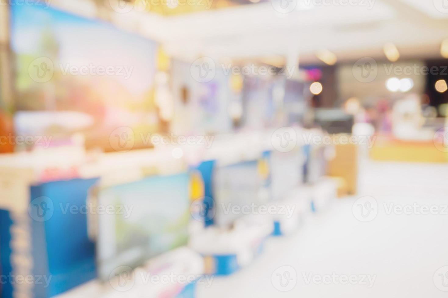 Television shelf in eletronic department store blurred background photo