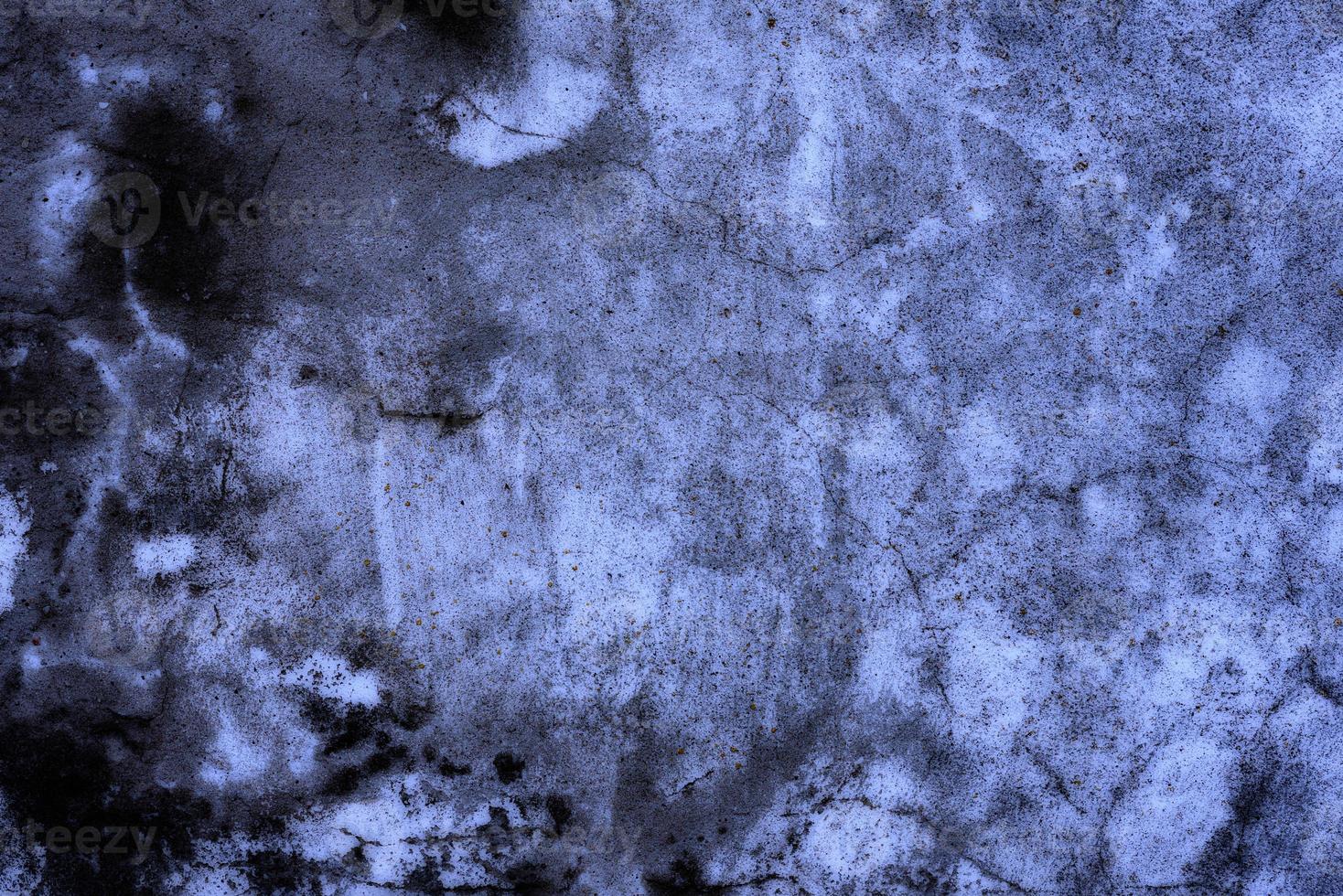 Texture of a concrete wall with cracks and scratches which can be used as a background photo