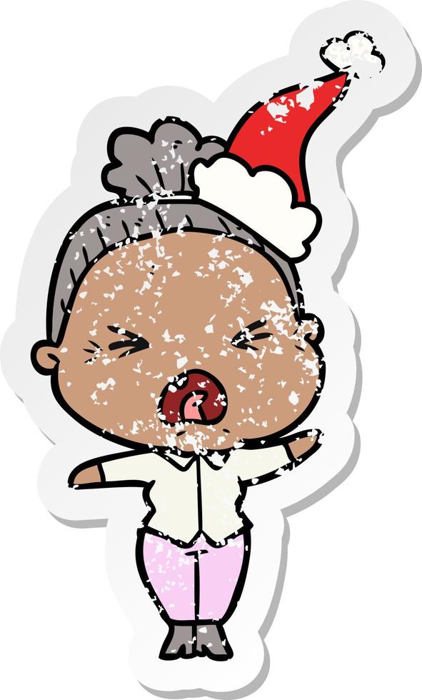 distressed sticker cartoon of a angry old woman wearing santa hat vector