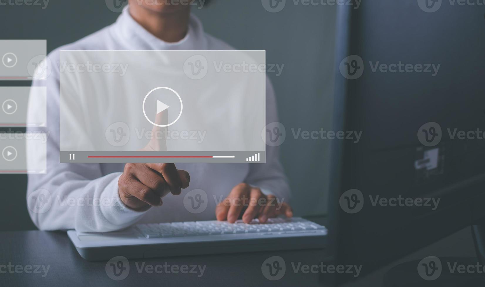 A young businesswoman is using a virtual monitor to watch some video, streaming onlinewatching video on internet. photo
