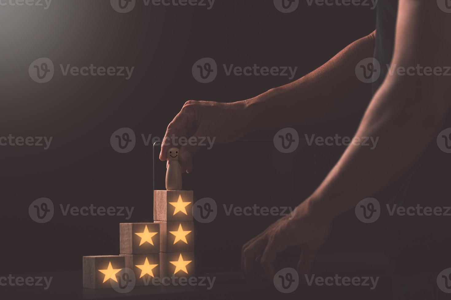 Young businessman holding a wooden doll placed on a wooden block, business growth idea. photo