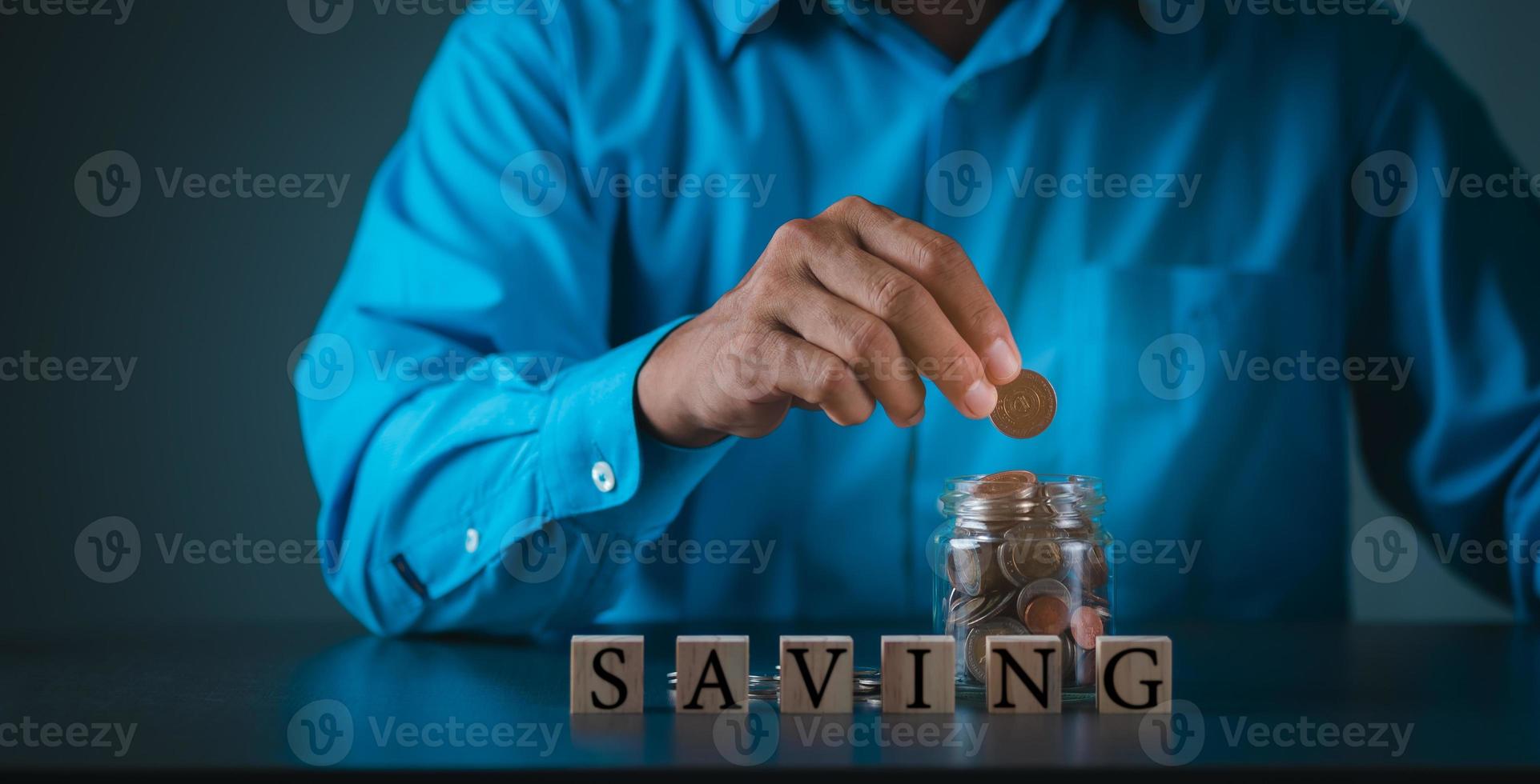 Young businessman pouring coins into the jar, future saving ideas, financial and banking. photo