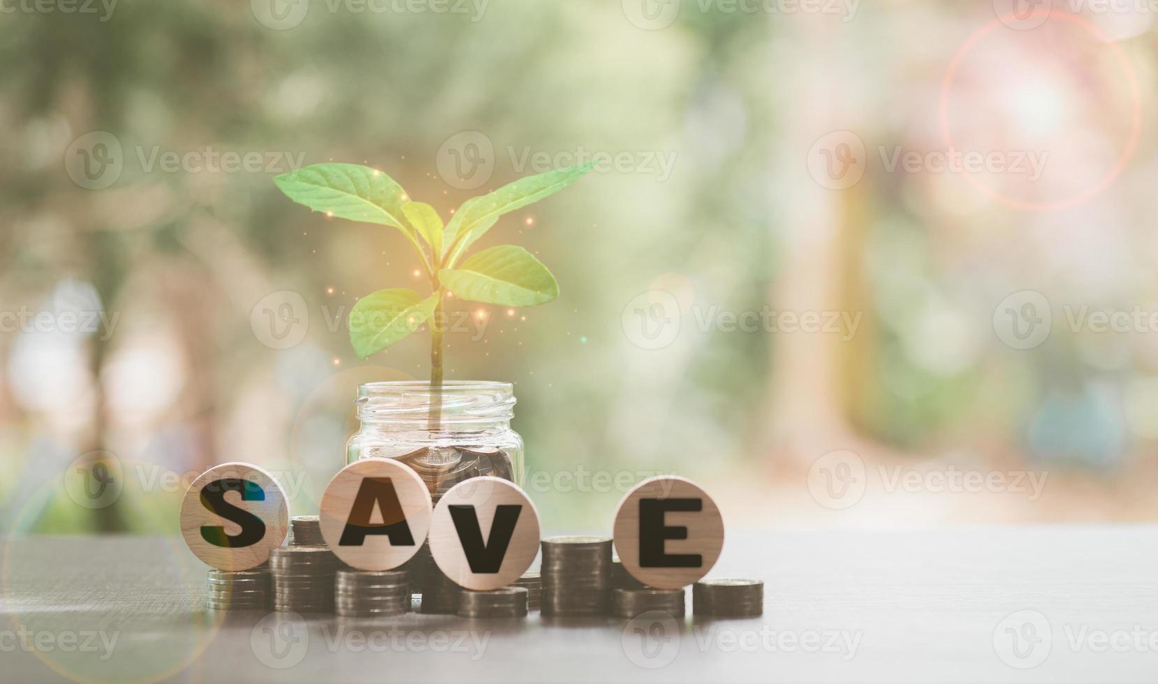 Pile of coins, glass jars, and treetops, all on the table, photo