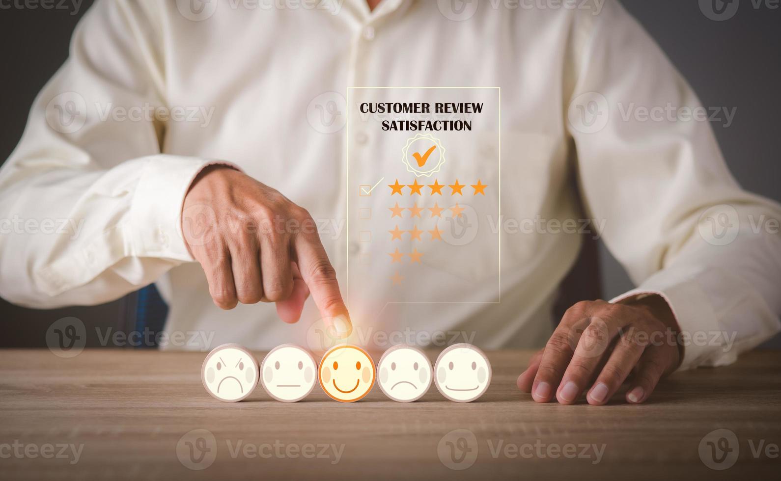 Young businessman pointing at a wooden block on the table, photo