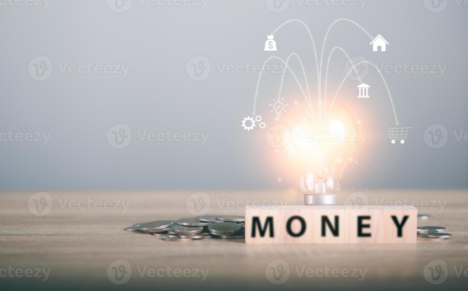 Light bulbs, wooden blocks, and stacks of coins were all on the wooden table. photo