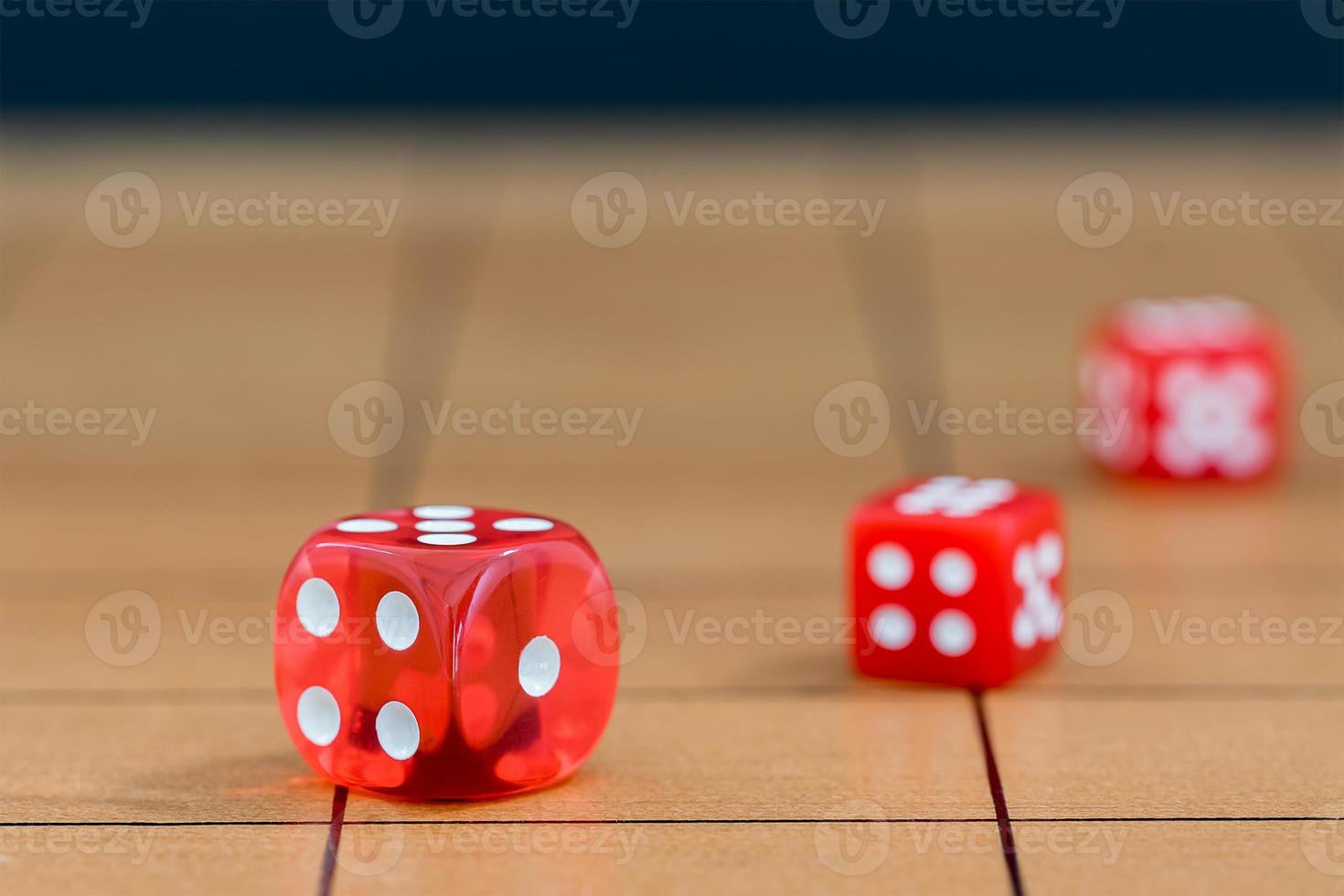 Red dices on wood board photo