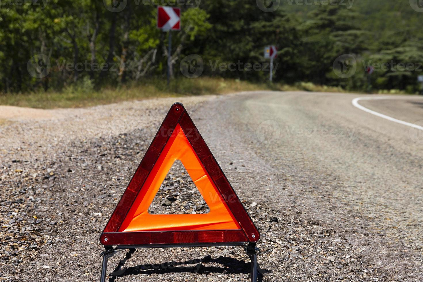 A car emergency stop sign is installed on the road. Danger on the road, warning. photo