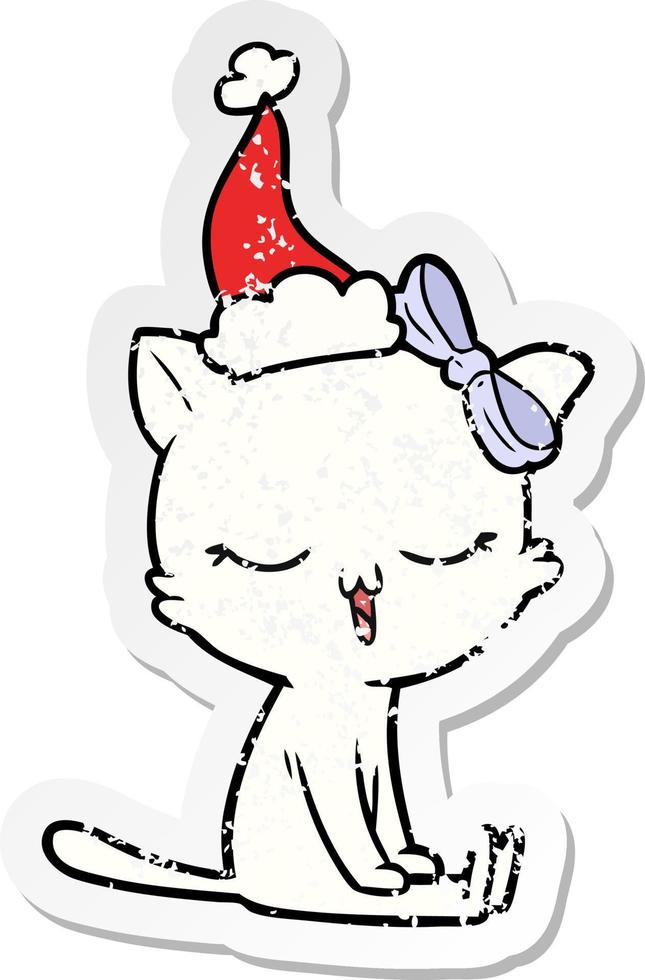distressed sticker cartoon of a cat with bow on head wearing santa hat vector