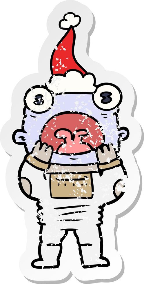 distressed sticker cartoon of a alien gasping in surprise wearing santa hat vector