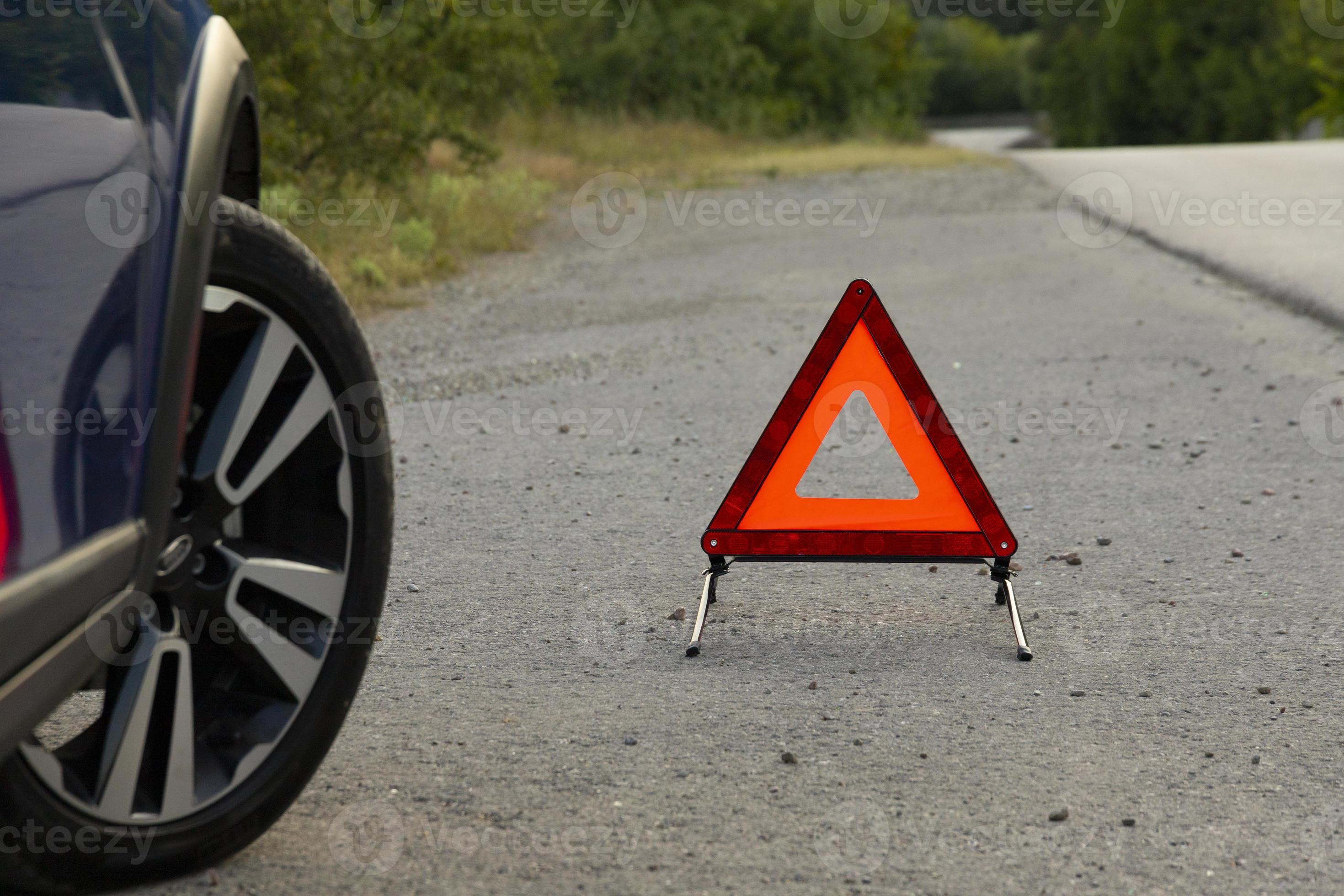 An emergency stop sign of a vehicle is installed on the road, next to