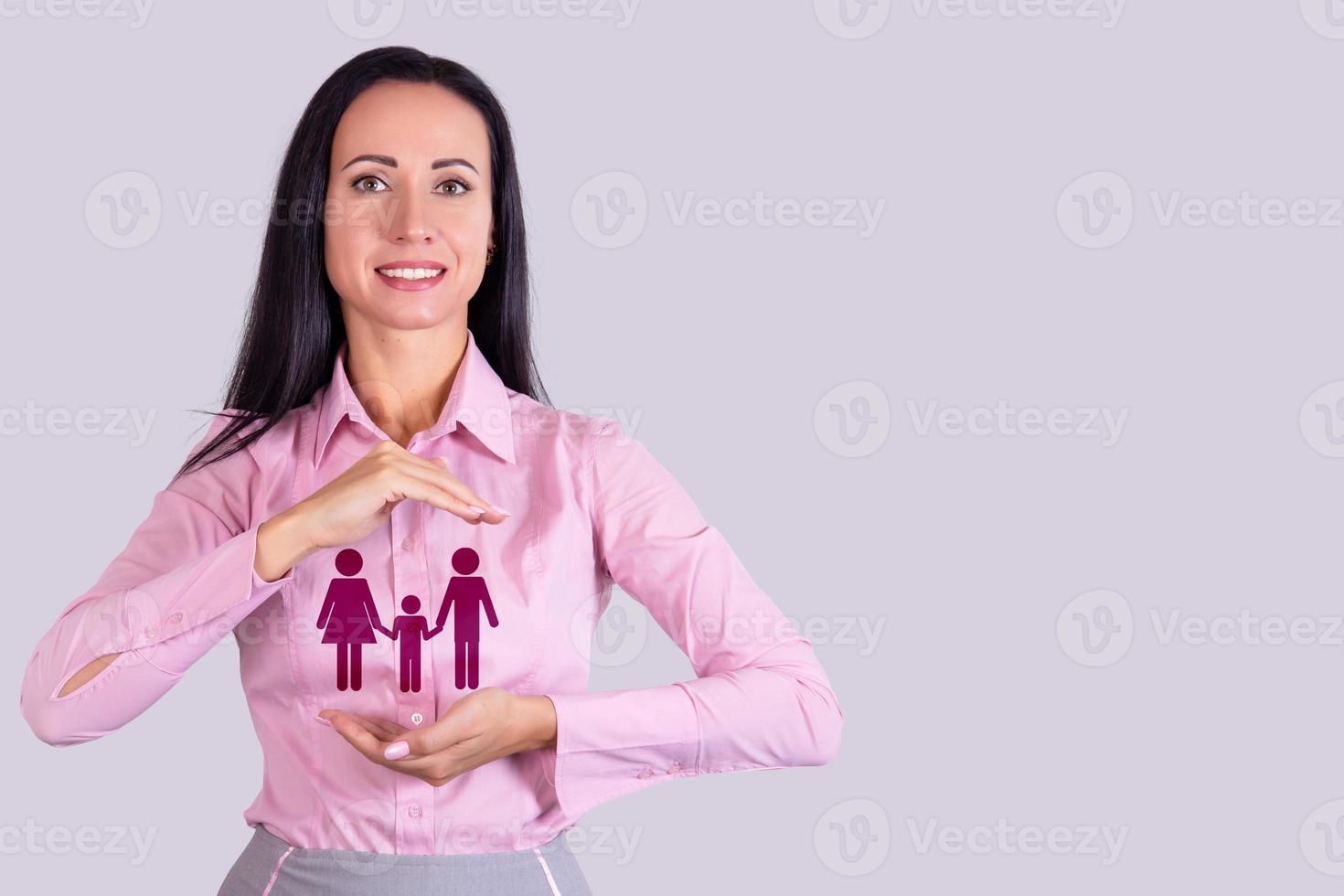 Family life insurance, family services and family support concepts. Business woman with protective gesture over family icon. Copy space. photo