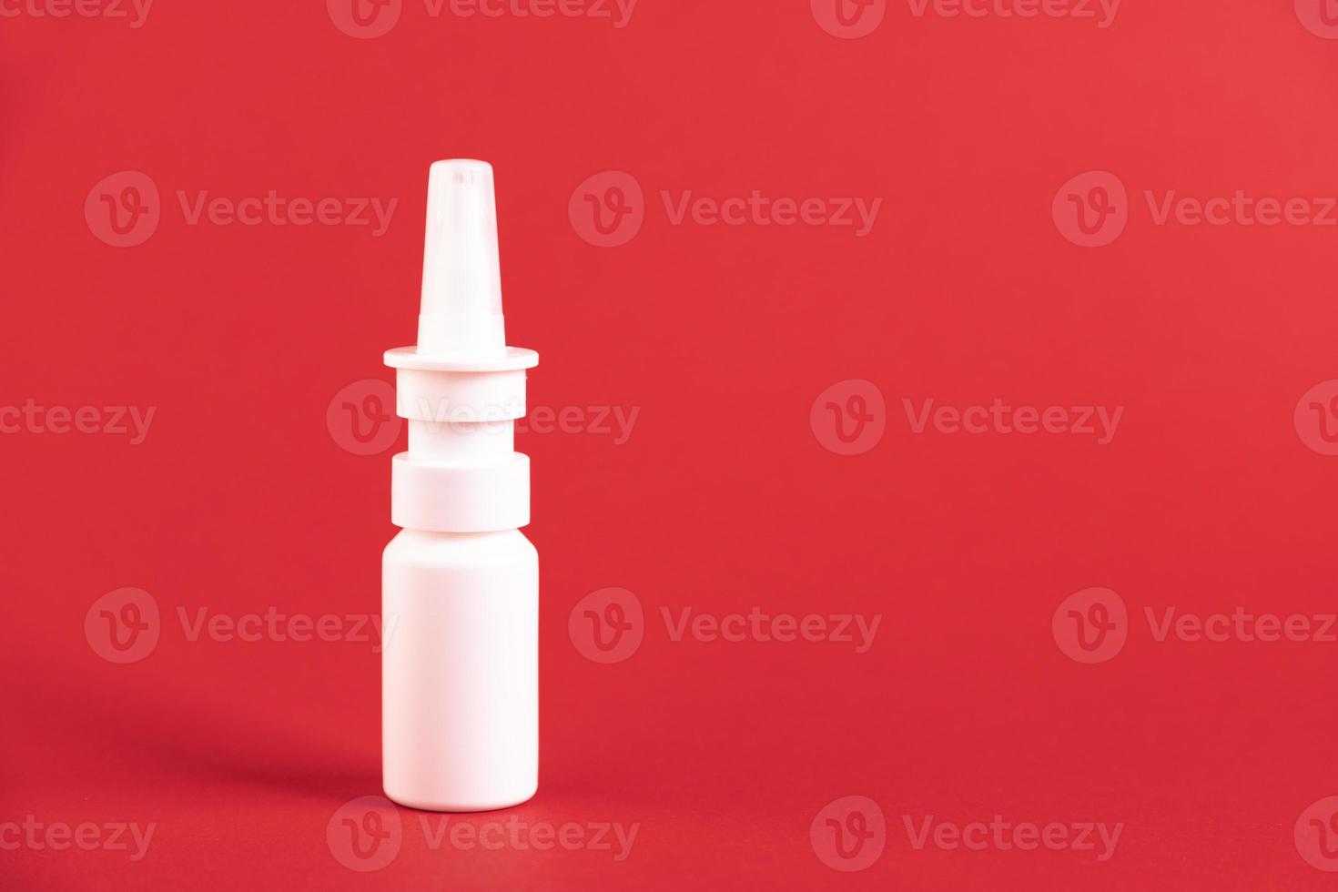 Medicinal nasal spray, on a red background. Copy space. photo