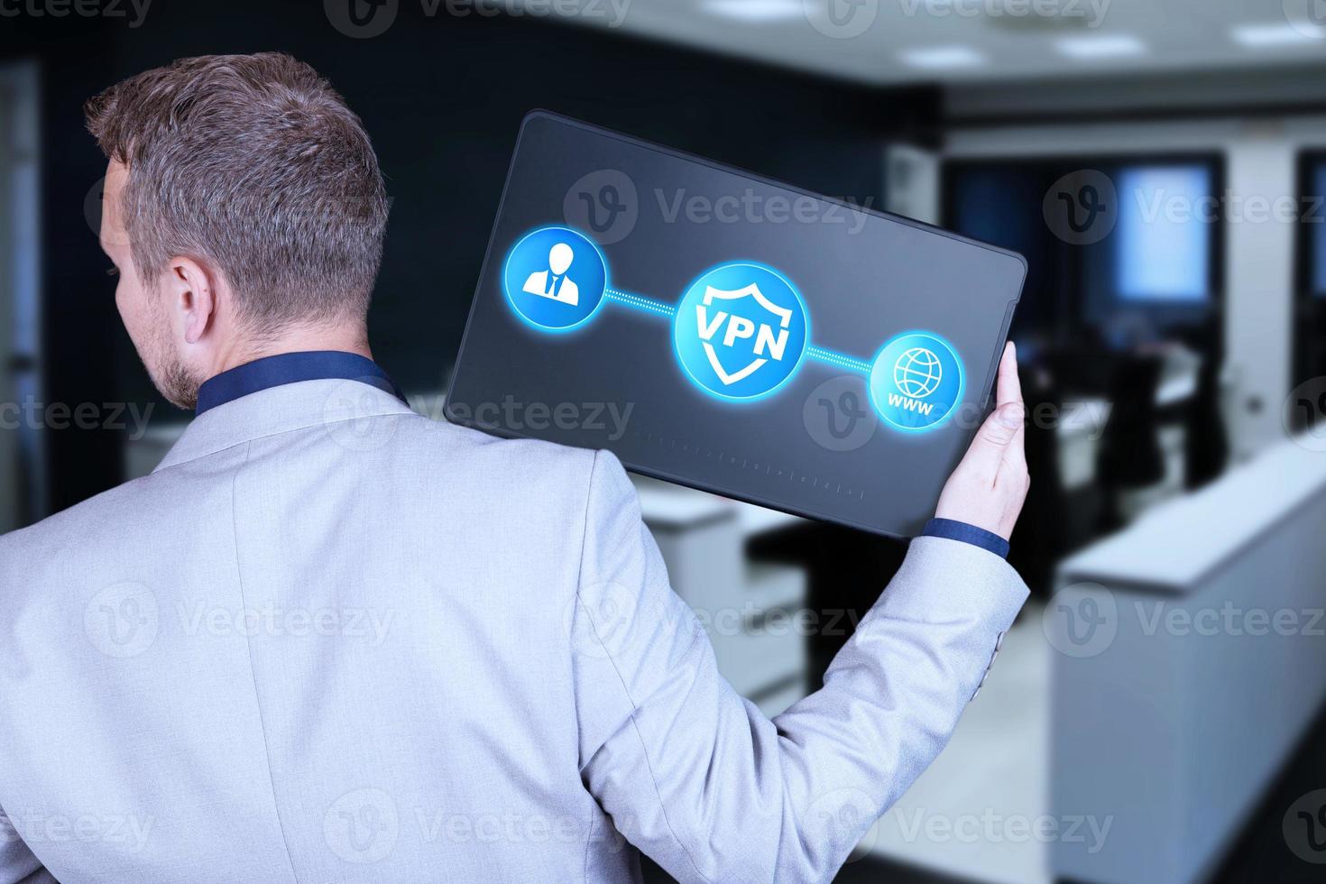 VPN concept, Internet protection technologies from surveillance, censorship, anonymity, security, Businessman stands with his back with a tablet and icons. photo